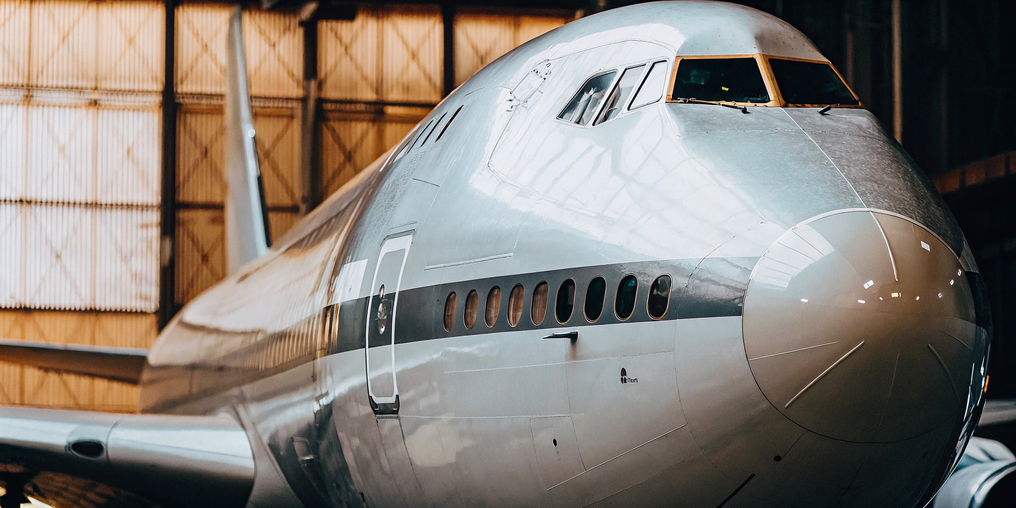 Boeing 747-8F freighter in teal livery standing on the tarmac