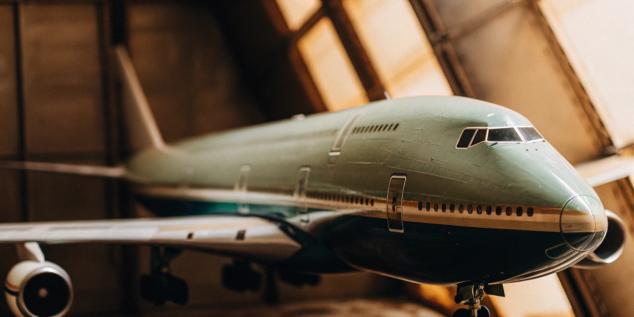 Boeing 747-8F freighter with its nose door open being loaded with heavy machinery